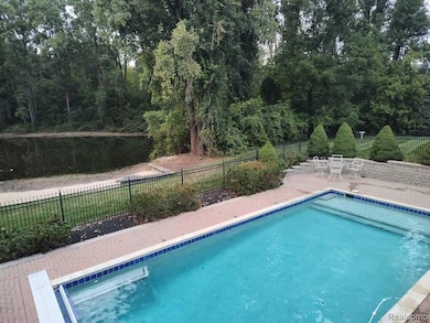View of swimming pool with a fenced backyard and a patio area