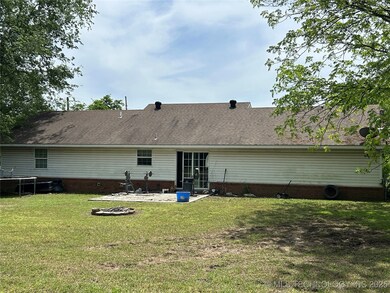 Back of house with a patio, a lawn, a trampoline,