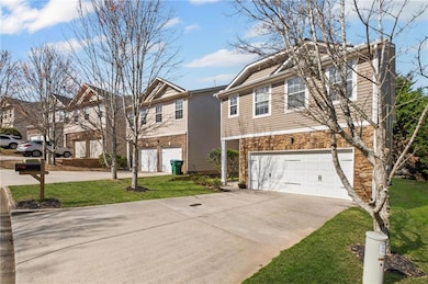 View of front of property featuring driveway, a ga