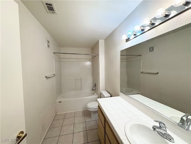 Full bathroom with vanity, toilet, tile patterned
