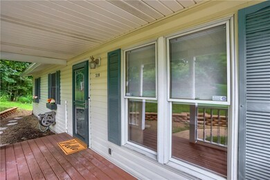 Quaint porch greets guests into the expansive home