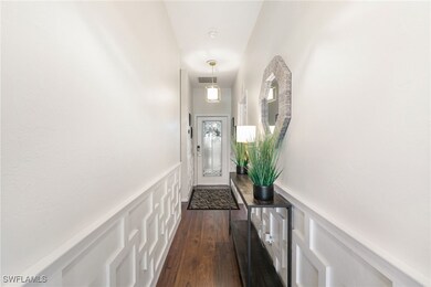 Doorway to outside with a decorative wall, dark wo
