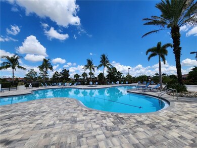 Community pool with a patio area and fence