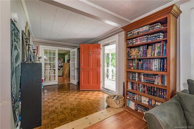 Foyer hall with entrance to master bedroom through french doors and open to living room