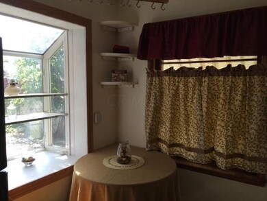 The kitchen features a greenhouse window