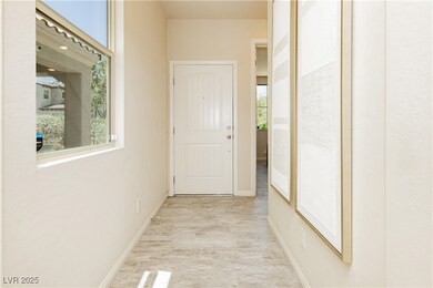 Corridor with light wood finished floors and baseb