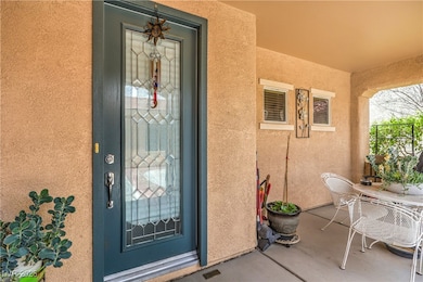 View of exterior entry featuring stucco siding