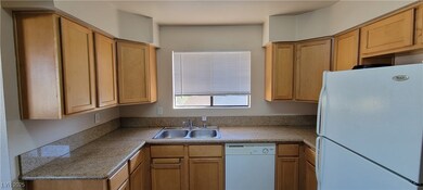 Kitchen with white appliances and a sink