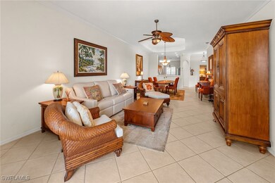 Living area featuring a raised ceiling, ceiling fa