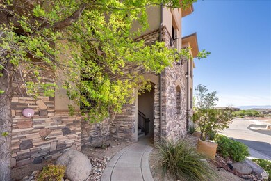 View of side of home featuring stone siding and stucco siding