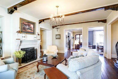 The focal point of this room is the whimsical chandelier and antiqued wood beams embellished with corbels and stained to complement the rich tones of the hardwood floors.
