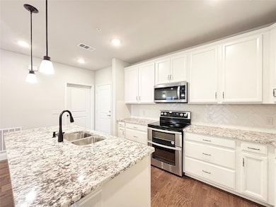 Kitchen featuring dark wood-style floors, visible 