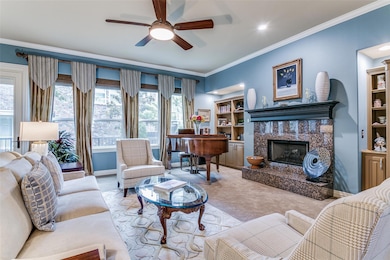 Large living room with fireplace with gas logs.  Built-ins on either side and new Pella windows adored by custom draperies.