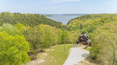 Bird's eye view with a wooded view and a water vie