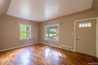 Entrance foyer with healthy amount of natural light and hardwood / wood-style floors