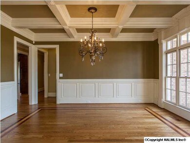 Formal dining room accented with a handcrafted coffered ceiling.