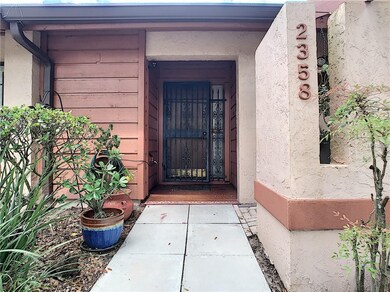 Private entrance with garden area to the right.