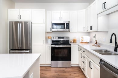 Outfitted with sleek stainless steel appliances and ample cabinetry, this gourmet kitchen is both beautiful and practical.