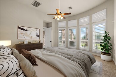 What a wonderful place to come home to, this stunning primary suite greets you with plush carpet, warm custom paint, high ceiling, ceiling fan with lighting, large windows with privacy shutters allowing in natural light brightening up this spacious primary bedroom, with extra space for a seating area.