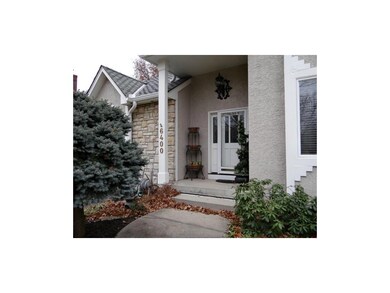 The large entryway is surrounded by landscaping.