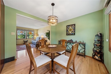 New light fixture, hardwood floors, and window in the dining room