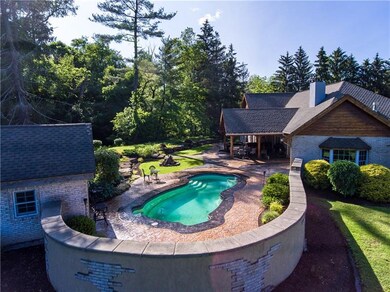The pool house to the left features a half bath/ch