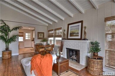 High beam ceilings, cozy fireplace & wood floors c