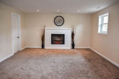 Family room with an electric fireplace.