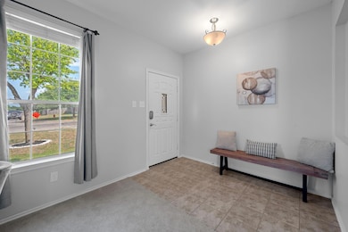 Foyer featuring baseboards and light tile pattern