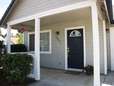 A covered front porch area with railing is a welco