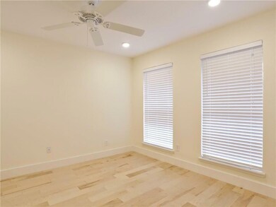 Spare room with baseboards, wood finished floors,