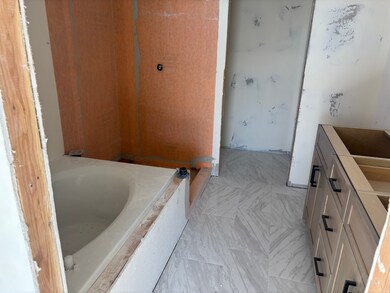 Full bath with vanity and a tub