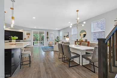 Dining room with wood finished floors and recessed
