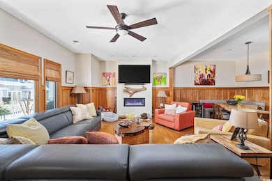 Living area featuring a wainscoted wall, visible v