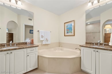 Bathroom featuring a garden tub, a stall shower, a