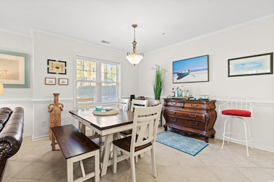 Tiled dining space with crown molding