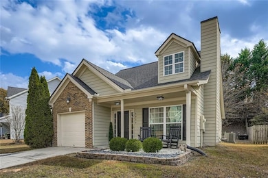 View of front of home with roof with shingles, a porch, concrete driveway, a garage, and a chimney