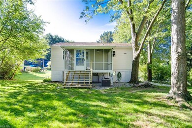 Back of property featuring central AC and a yard