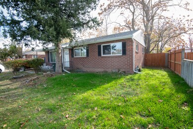 View of front of house with brick siding and a fenced backyard