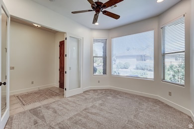 Spare room featuring light colored carpet, light tile patterned floors, a ceiling fan, and recessed lighting