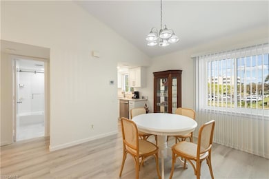 Dining area with an inviting chandelier, sink, lig