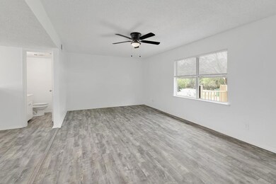 Spare room featuring a ceiling fan, wood finished