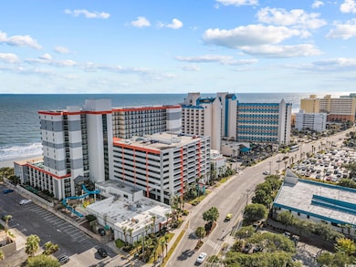 Birds eye view of property with a water view
