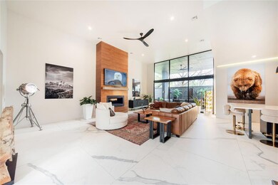 Tiled living room with floor to ceiling windows, c