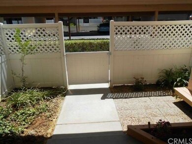 Clean Courtyard with Vinyl Fencing and Flower Beds