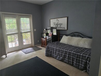 Carpeted bedroom with baseboards, french doors, an