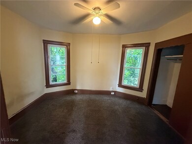 Unfurnished bedroom featuring carpet flooring, a ceiling fan, and a closet