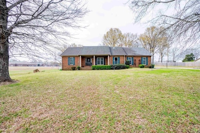 Ranch-style home featuring a front yard, fence, an