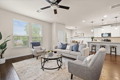 Living room with visible vents, recessed lighting