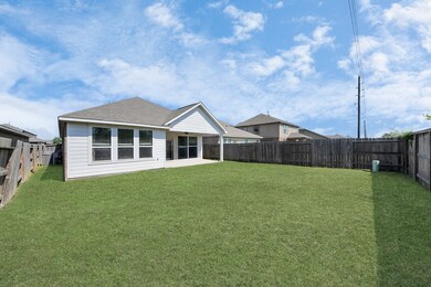 Spacious backyard with a well-maintained lawn, pri